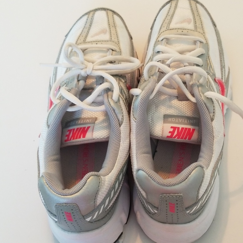 Pink and white Nike shoes